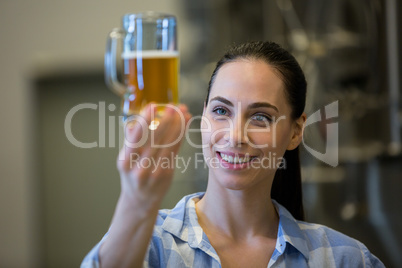 Close-up of female brewer testing beer