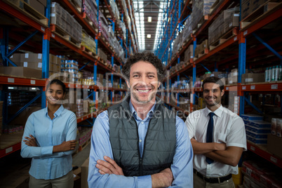 Focus of happy businessman posing face to the camera with his co