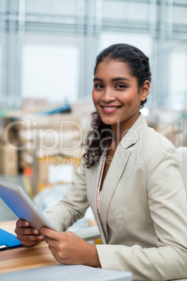 Portrait of manager is smiling and holding a tablet