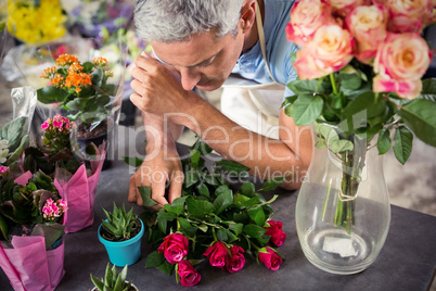 Male florist arranging flowers