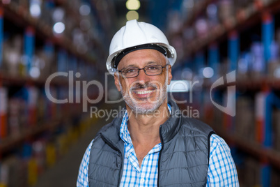 Portrait of happy worker is posing with hard hat