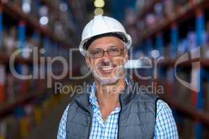Portrait of happy worker is posing with hard hat