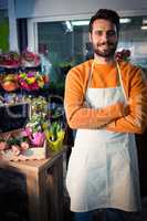 Male florist standing with arms crossed