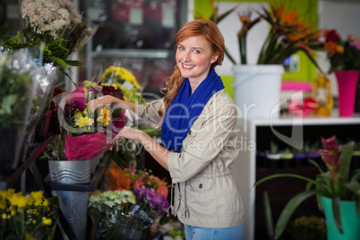 Female florist arranging flower bouquet