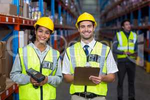 Smiling worker wearing yellow safety vest looking at camera