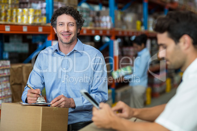 Focus of manager is smiling and posing during work