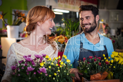Couple holding crate of flower bouquet