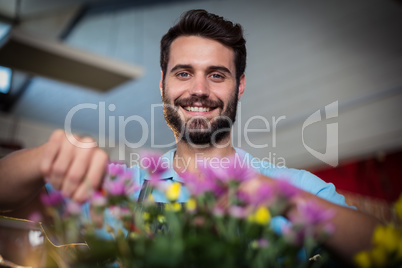 Portrait of male florist preparing flower bouquet