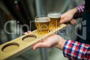 Brewer holding beer sampler tray