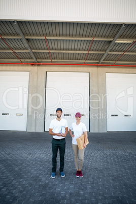 Delivery people are posing and holding goods