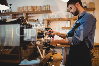 Man taking coffee from espresso machine