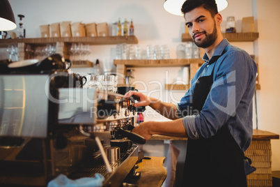 Man taking coffee from espresso machine