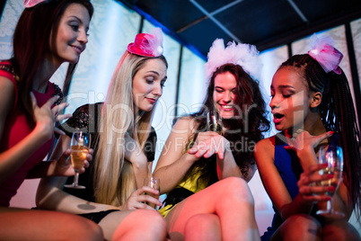 Woman showing engagement ring to her friends
