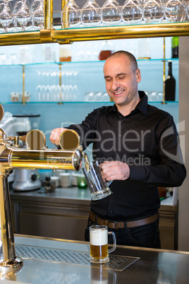 Bar tender filling beer from bar pump