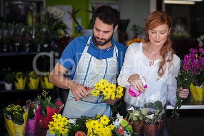 Couple preparing flower bouquet