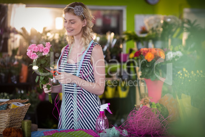 Female florist preparing flower bouquet