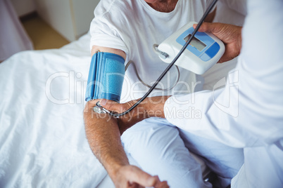 Nurse measuring the blood pressure of a senior man