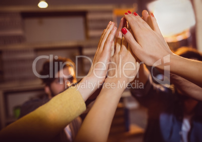 Colleagues giving high five at office