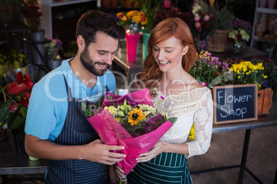 Couple holding flower bouquet