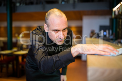 Bar tender cleaning bar counter