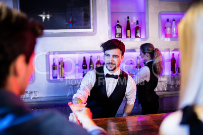 Waiter serving cocktail