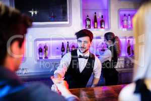 Waiter serving cocktail