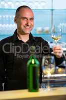 Waiter holding glass of white wine