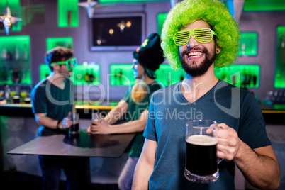 Man holding beer glass and smiling