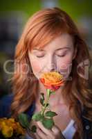 Female florist smelling a rose flower