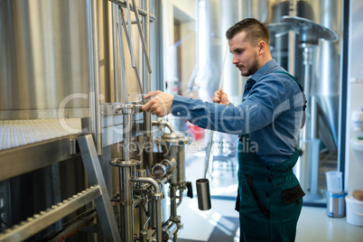 Brewer working at brewery