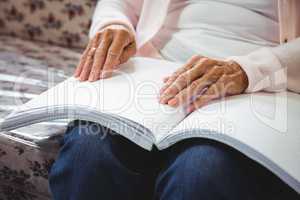 Senior woman using braille to read