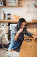 Woman using mobile phone at office