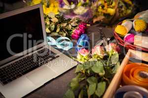 Laptop and florist supplies on the table