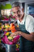 Male florist watering flowers with watering can