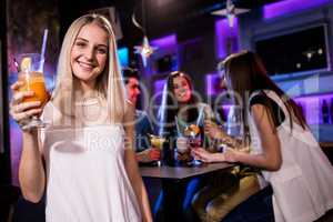 Portrait of beautiful woman having a cocktail