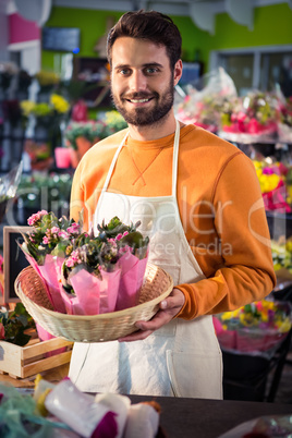 Male florist holding flower bouquet at flower shop Male florist holding flower bouquet at flower shop