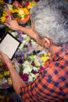Male florist using digital tablet