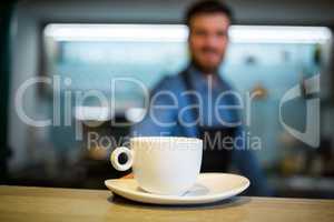 Waiter offering cup of coffee