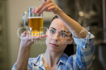 Close-up of female brewer testing beer