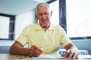 Senior man using a colouring book