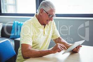 Senior man using a digital tablet