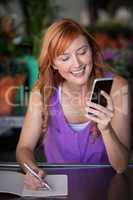 Female florist using mobile phone