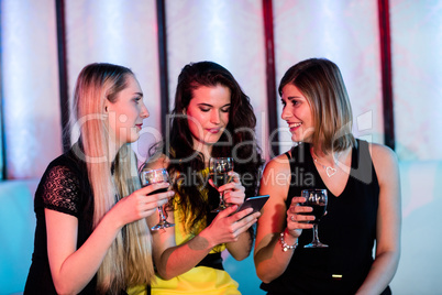 Friends interacting each other while having wine Friends interacting each other while having wine