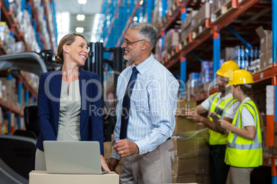 Portrait of happy managers are looking each other and smiling