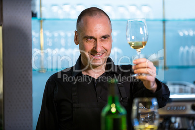 Waiter looking at a glass of wine