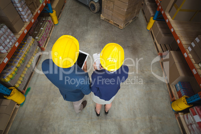 High angle view of managers with hard hat holding tablet and cli