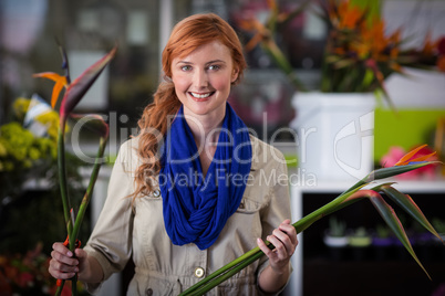 Smiling female florist arranging flowers