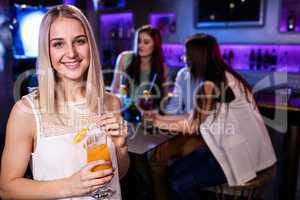 Portrait of beautiful woman having a cocktail