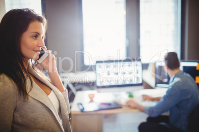 Graphic designer talking on mobile phone