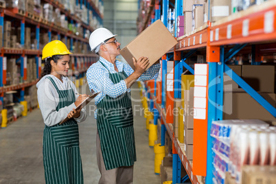 Workers colleague carrying and organizing box